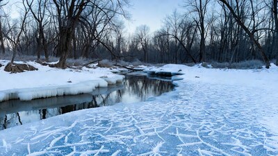 Icy River in Snowy Forest