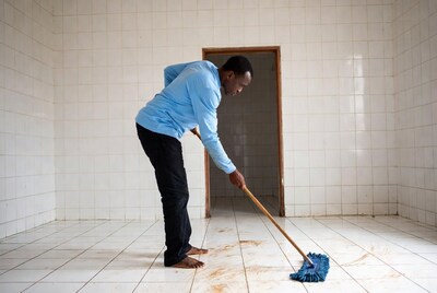 African man mopping tiled floor
