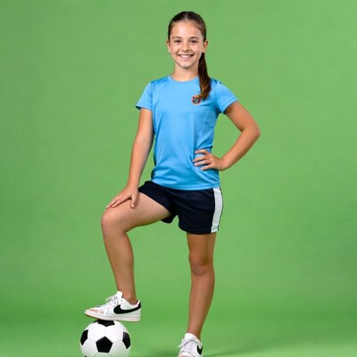 Girl balancing soccer ball on foot