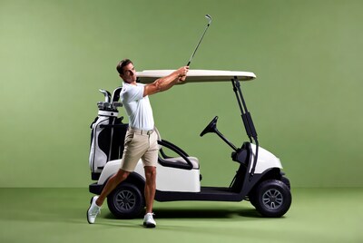 Man swinging golf club by cart