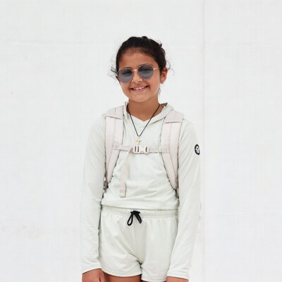 Smiling Asian girl in sunglasses with backpack