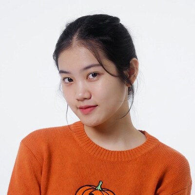Asian woman in orange pumpkin sweater
