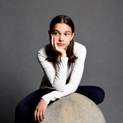 Girl thinking on large rock