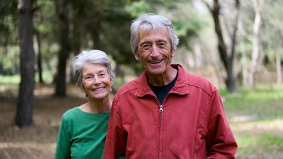 Elderly couple smiling in forest