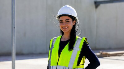 Smiling woman in hard hat and hi-vis vest