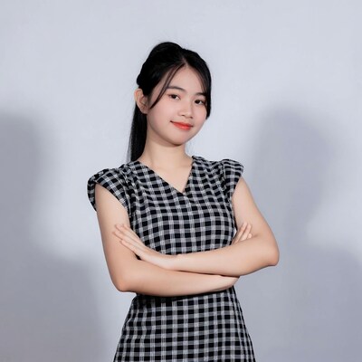 Asian woman arms crossed in plaid dress