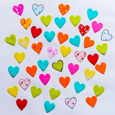 Colorful paper hearts on white background