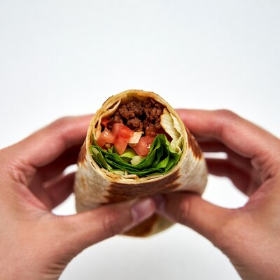 Hands Holding Beef Burrito