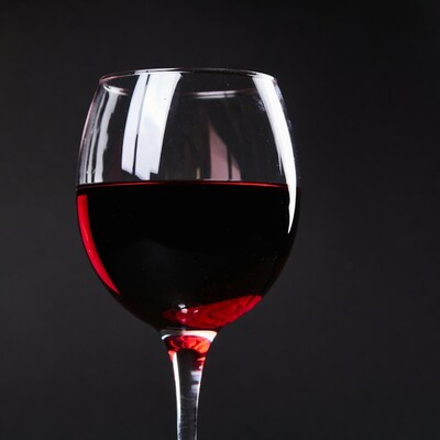 Red wine glass on black background