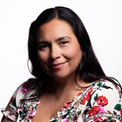 Latino woman smiling in floral blouse