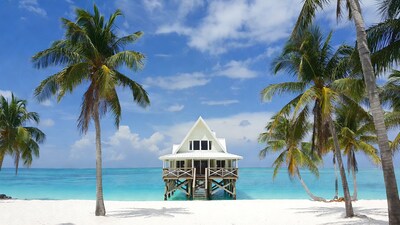 White stilt house on tropical beach