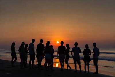 Group silhouettes at beach sunset