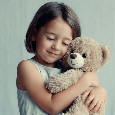 Girl hugging teddy bear