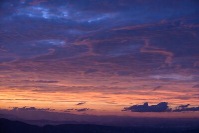 Vibrant Sunset over Mountains and City