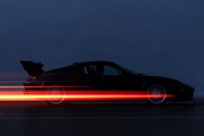Black Porsche 911 speeding with motion blur