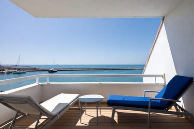 Balcony with Loungers Overlooking Harbor Sea