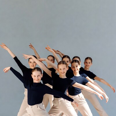 Girls dancing in black tops beige pants
