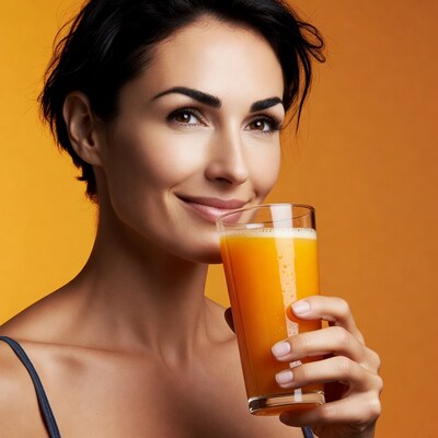 Woman holding orange juice glass
