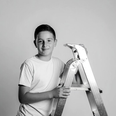 Boy holding ladder