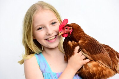 Girl holding red hen