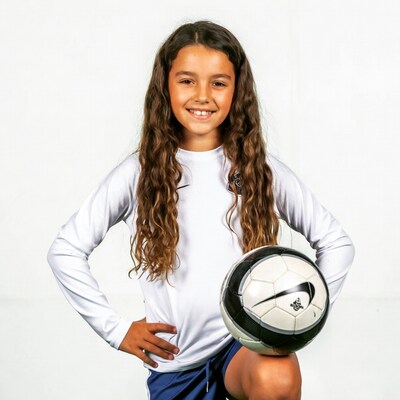 Girl holding soccer ball