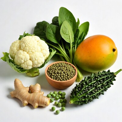 Fresh vegetables and mango on white background
