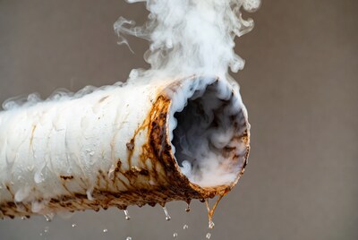 Rusty Pipe Leaking Steam and Water