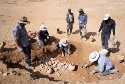 Archaeologists excavating pottery in desert