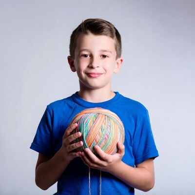 Boy holding colorful yarn ball