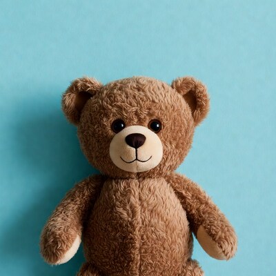Brown teddy bear on blue background