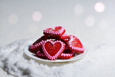 Stack of pink heart cookies on plate
