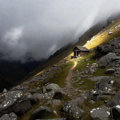 Wooden Cabin on Misty Mountain Slope