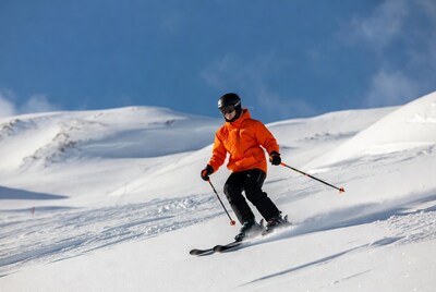 Woman skiing down snowy slope