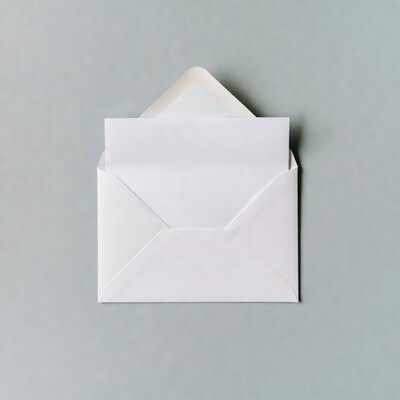 Open white envelope on gray background