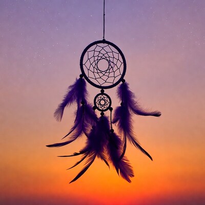 Dreamcatcher hanging against sunset sky