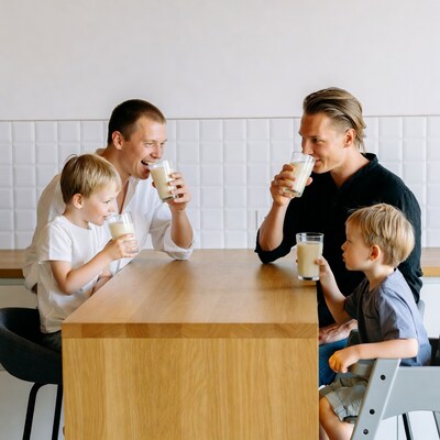 Family drinking milk at kitchen table