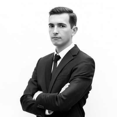 Young man in suit arms crossed