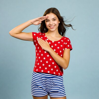 Girl saluting in stars shirt and striped shorts