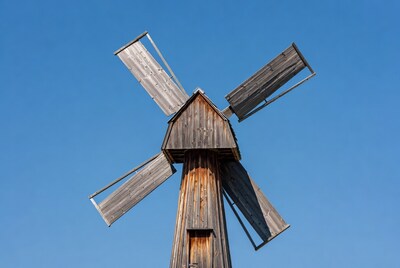 Wooden windmill against blue sky