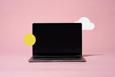 Laptop with sun and cloud on pink background