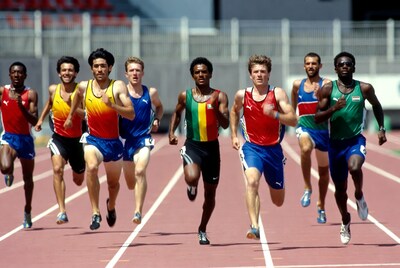 Male runners sprinting on track
