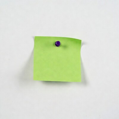 Green sticky note with purple push pin