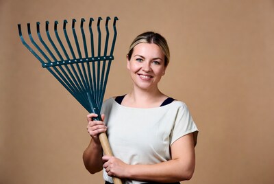 Woman holding green garden rake