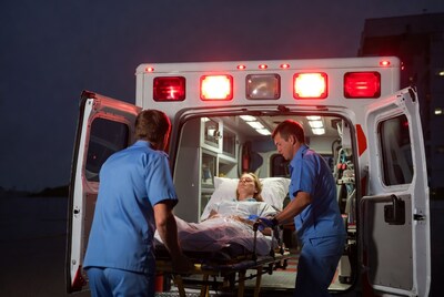 Paramedics wheeling patient from ambulance