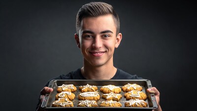 Young man holding star cookies