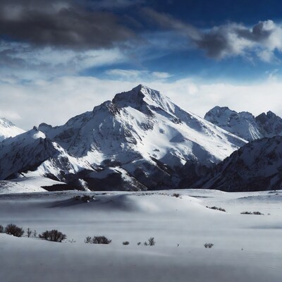 Snowy Mountain Peaks Under Dramatic Clouds