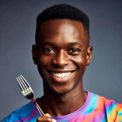African-American man holding fork smiling