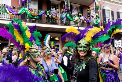 Women in Mardi Gras masks and feathers