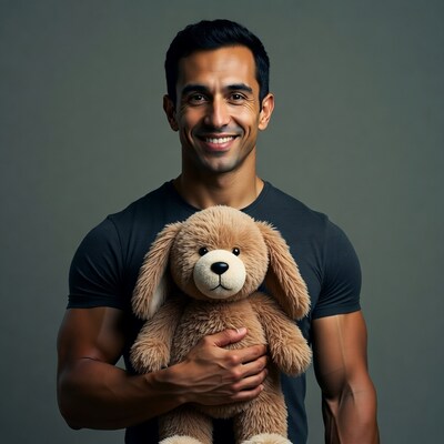 Muscular man holding teddy bear