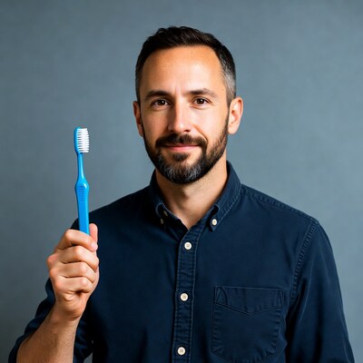 Man holding blue toothbrush